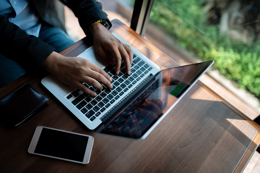 Businessman uses smartphone to share internet connection to analyze investment risks in the stock market, investor broker analyzing indexes, financial chart trading online investment data